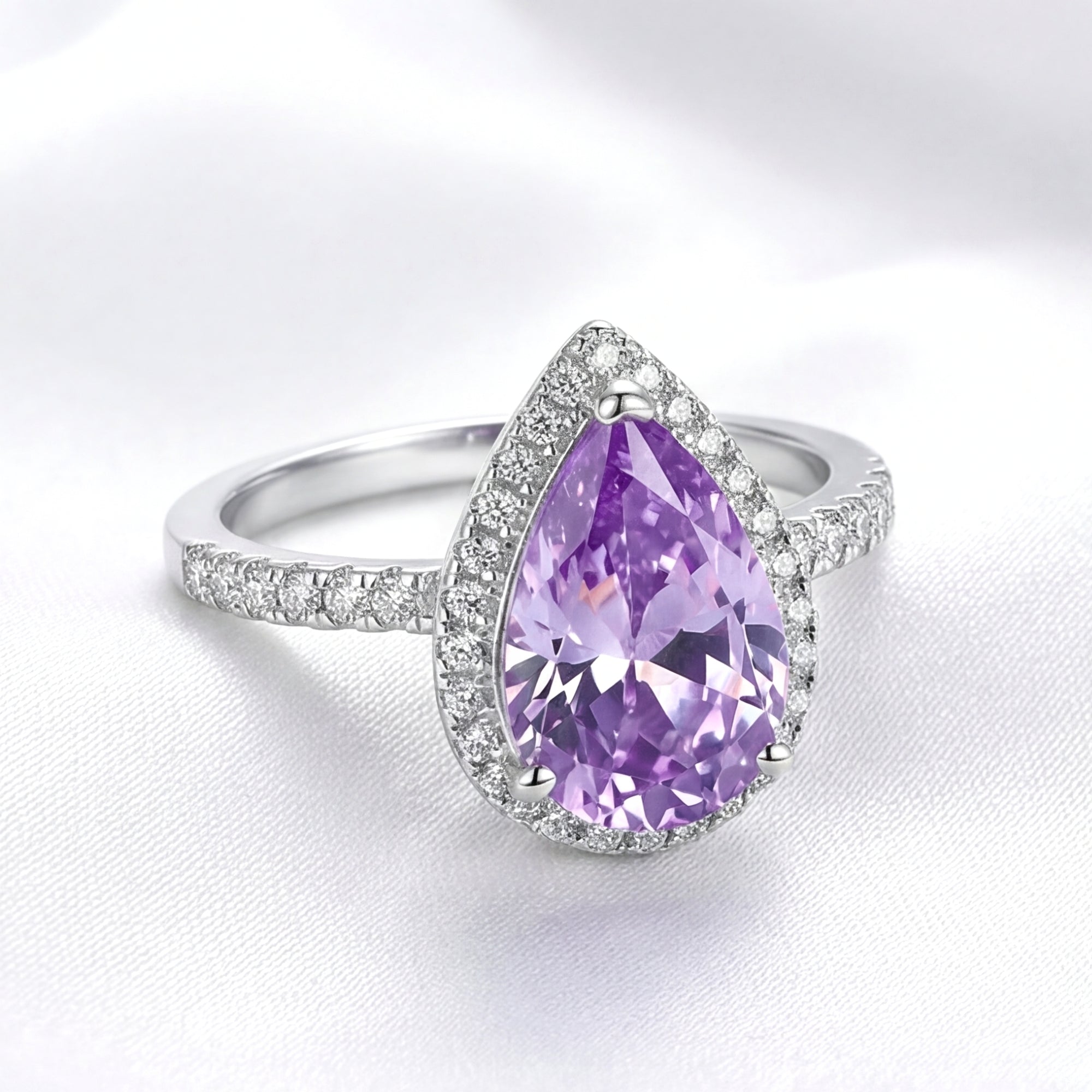 Angled view of the Odette teardrop simulated amethyst halo ring in S925 sterling silver with a pavé band.