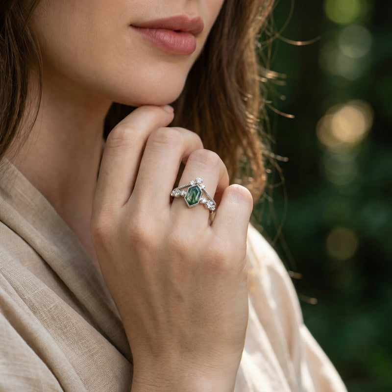Model wearing the sterling silver kite cut moss agate and diamond ring duo on her finger.