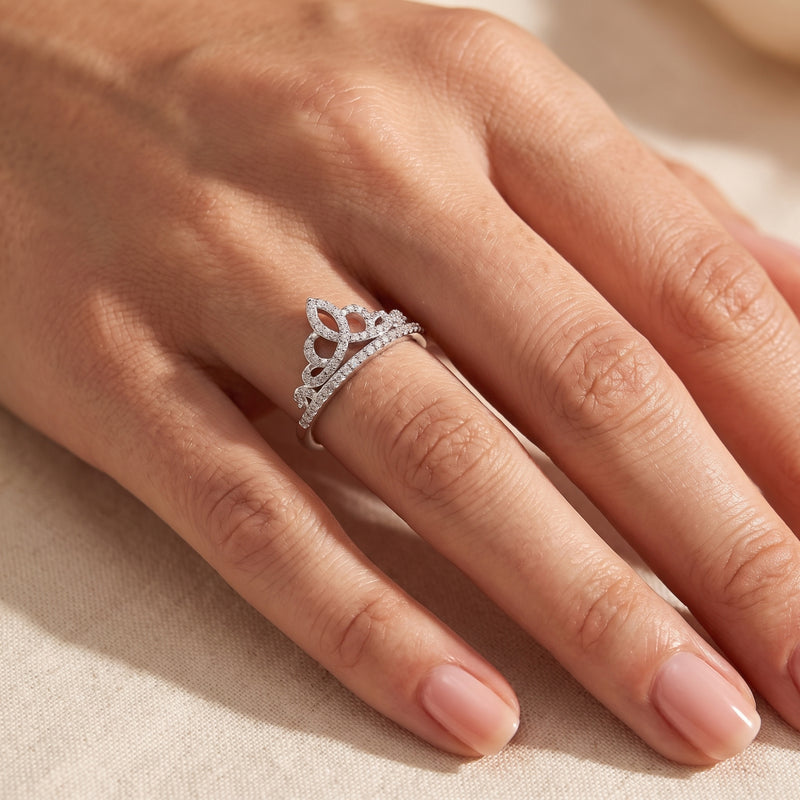 Silver tiara crown ring with cubic zirconia pave stones worn on a finger, viewed from above.