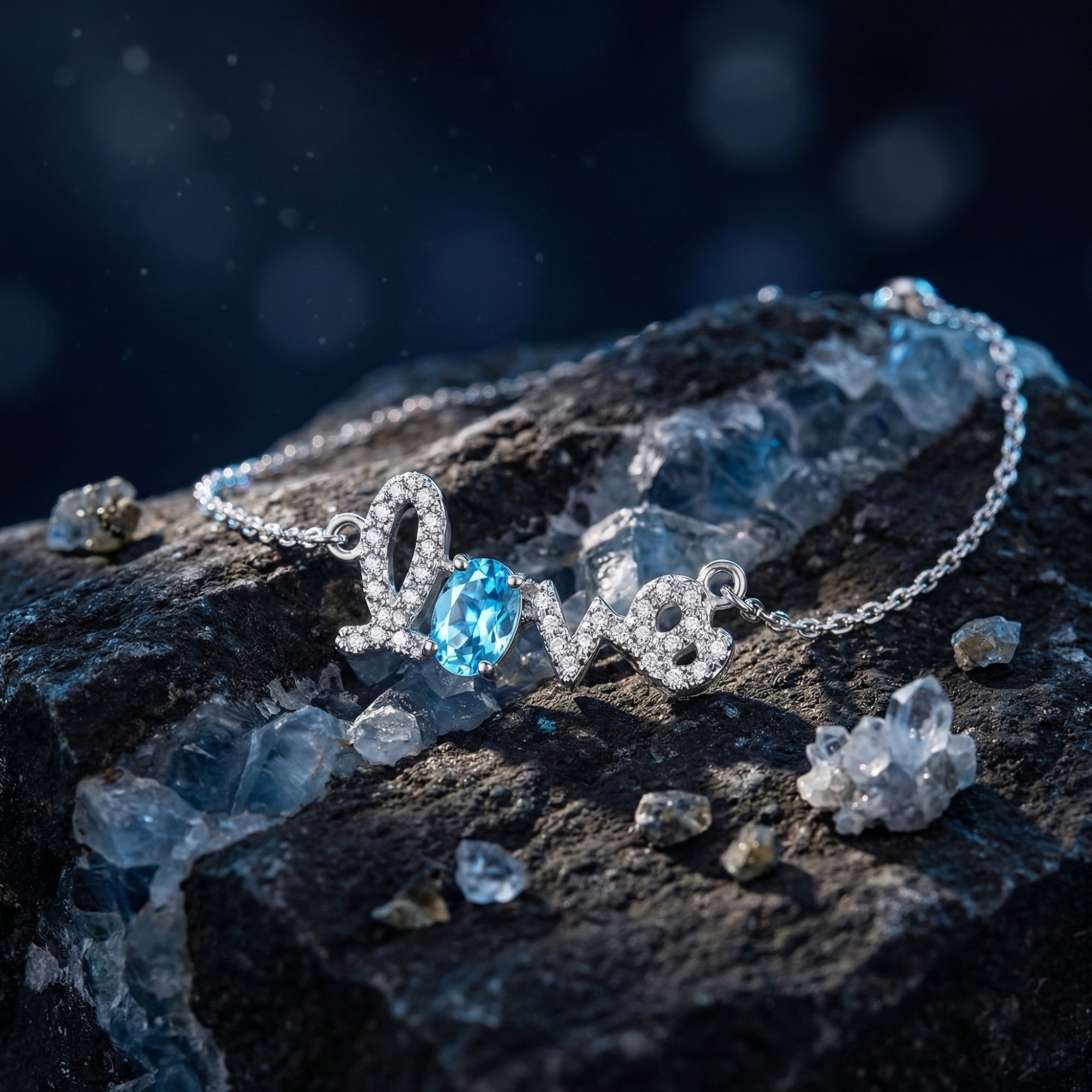 Macro view of the oval Swiss Blue Topaz and pavé stones in the Love script of the silver bracelet.