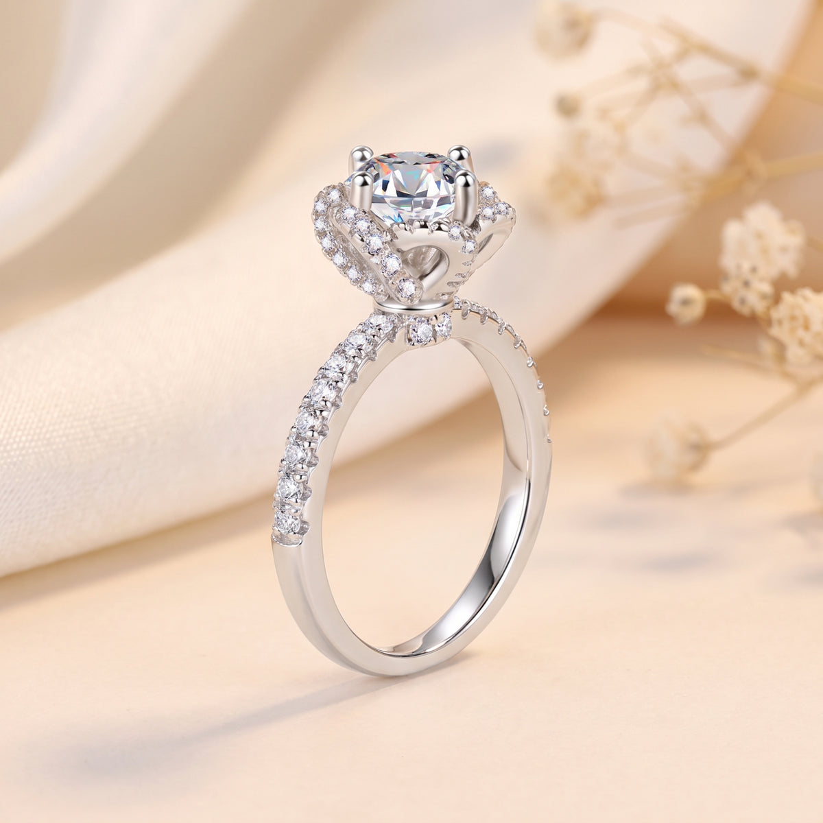 Side profile of a silver rosette swirl halo ring showing the round-cut simulated diamond and pavé setting.