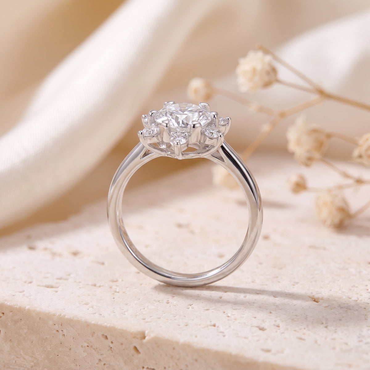 Side profile of a sterling silver snowflake ring showing the band and raised stone setting.