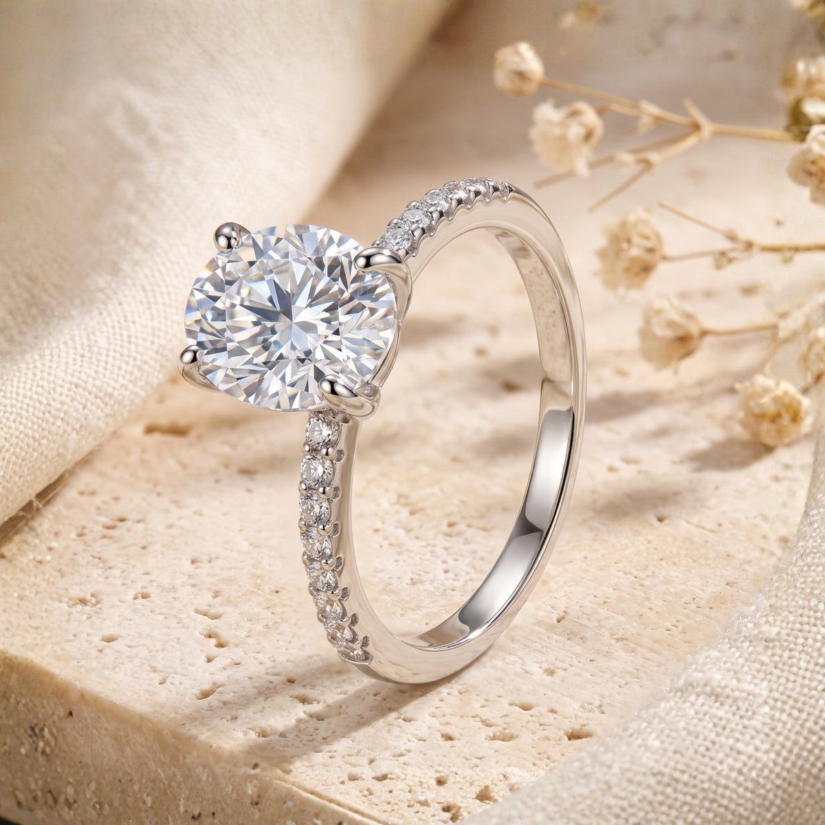 Side profile of the silver ring showcasing the prong-set stone and pavé accents along the slender band.