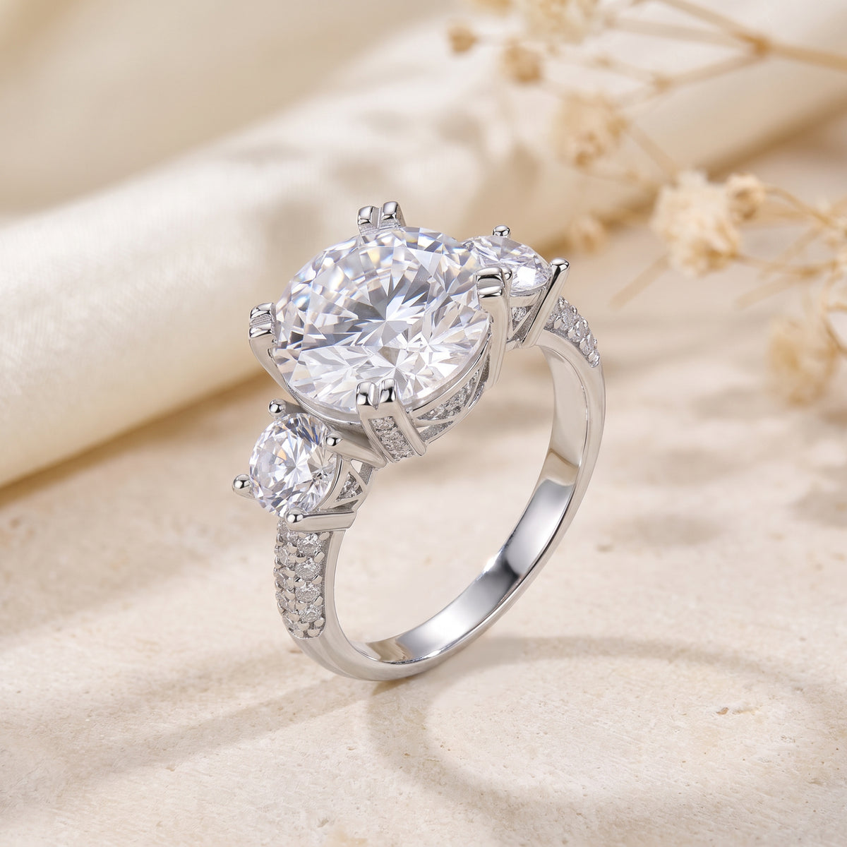 Angled close-up of the silver ring revealing double-prong setting and pave band details.