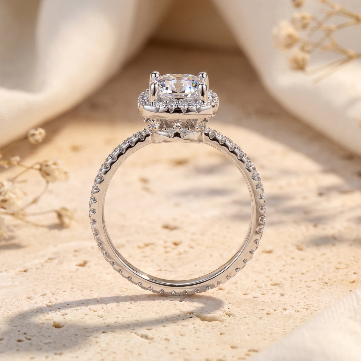 Side profile of a sterling silver cushion halo ring showing the stone setting and pavé band.