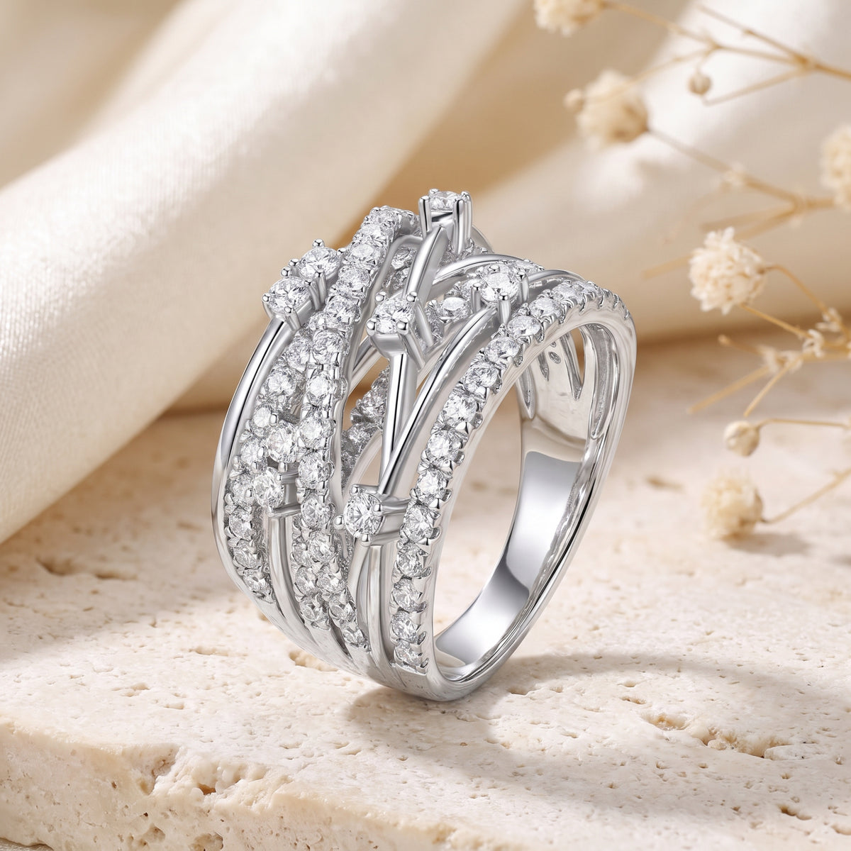 Front-angled macro view of the Aria ring's interlaced solid white gold bands and prong-set A5 Cubic Zirconia stones.