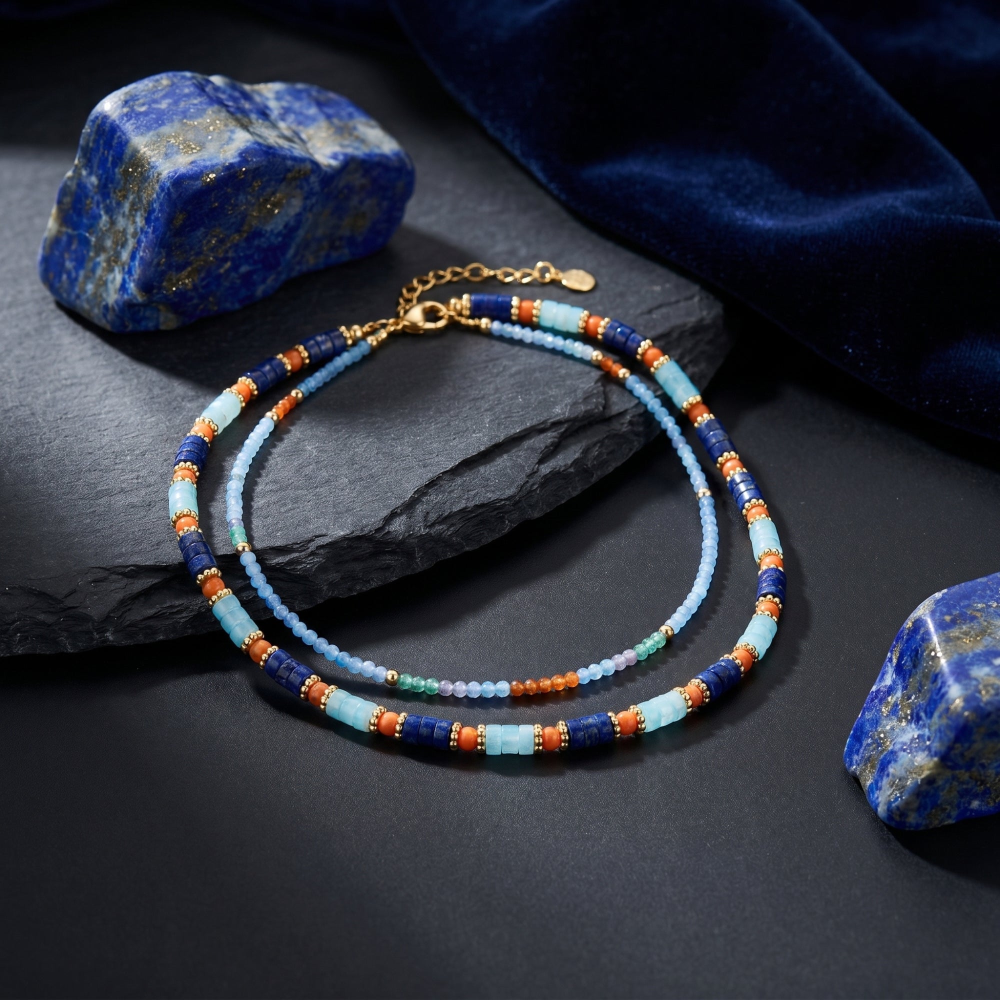 Double-strand gold plated necklace with 5mm lapis and colorful gemstone beads displayed on a dark lifestyle setting.