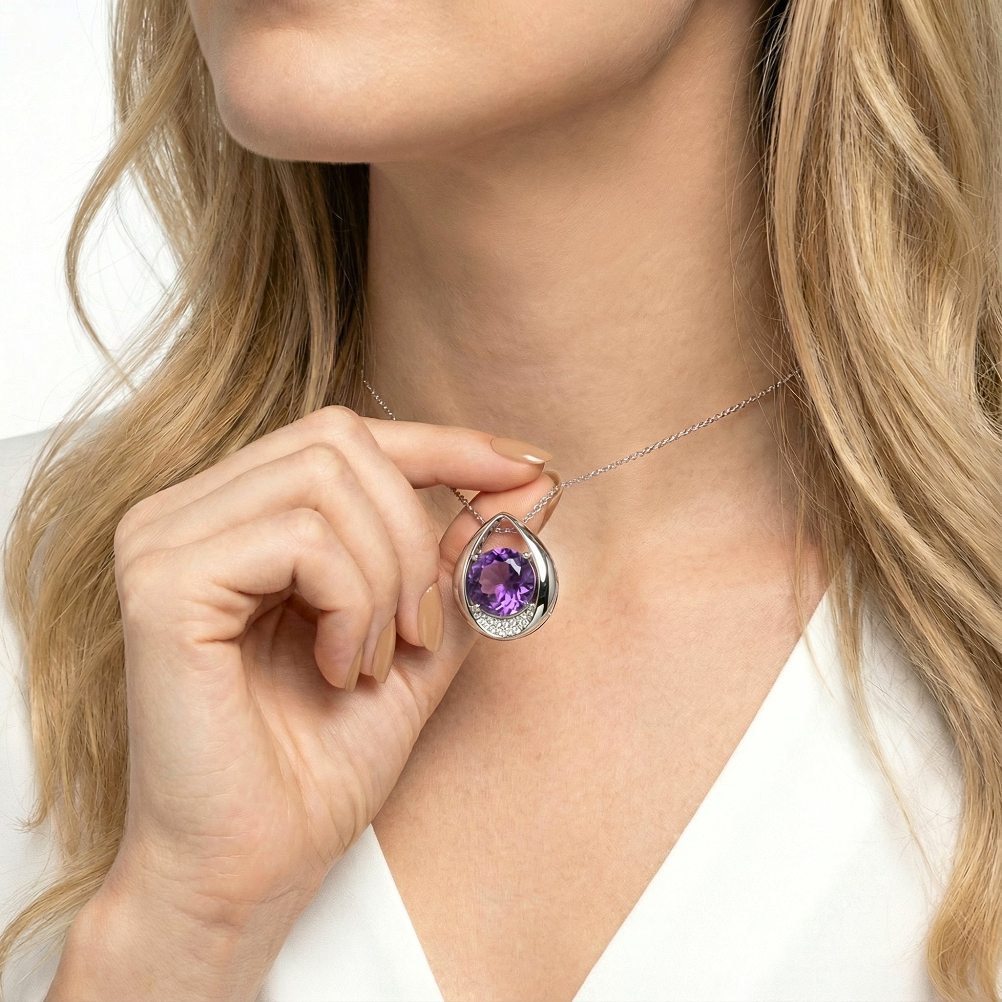 Woman's hand holding the S925 sterling silver amethyst drop pendant necklace to show scale and detail.