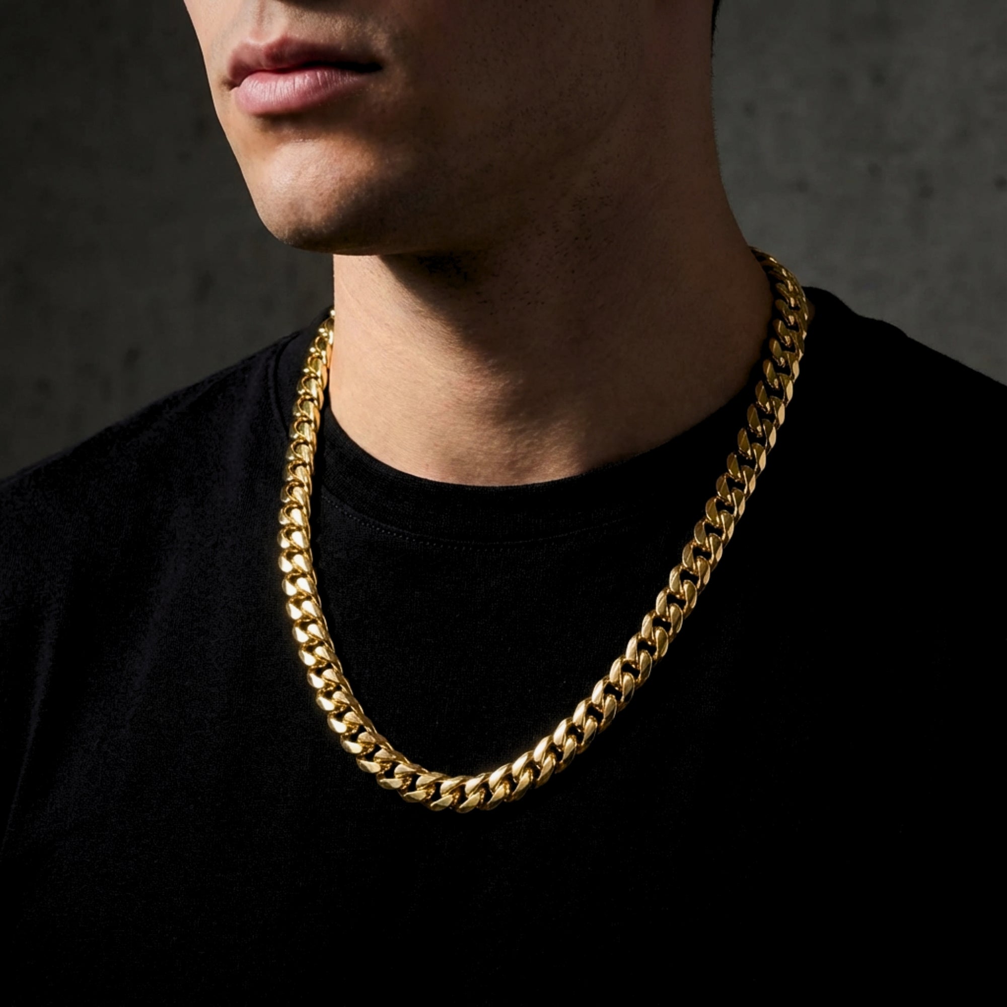Front view of a man wearing a 10mm gold-toned stainless steel Cuban link chain.