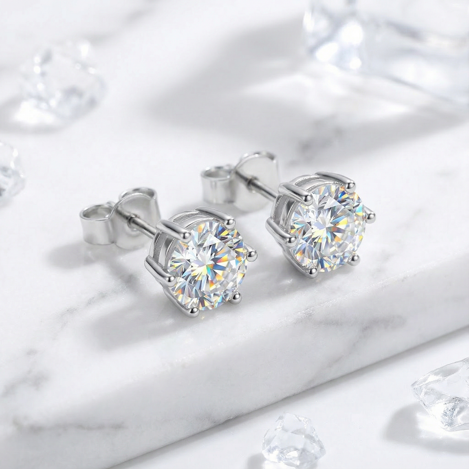 Round cut simulated diamond stud earrings in S925 sterling silver on a white marble surface.