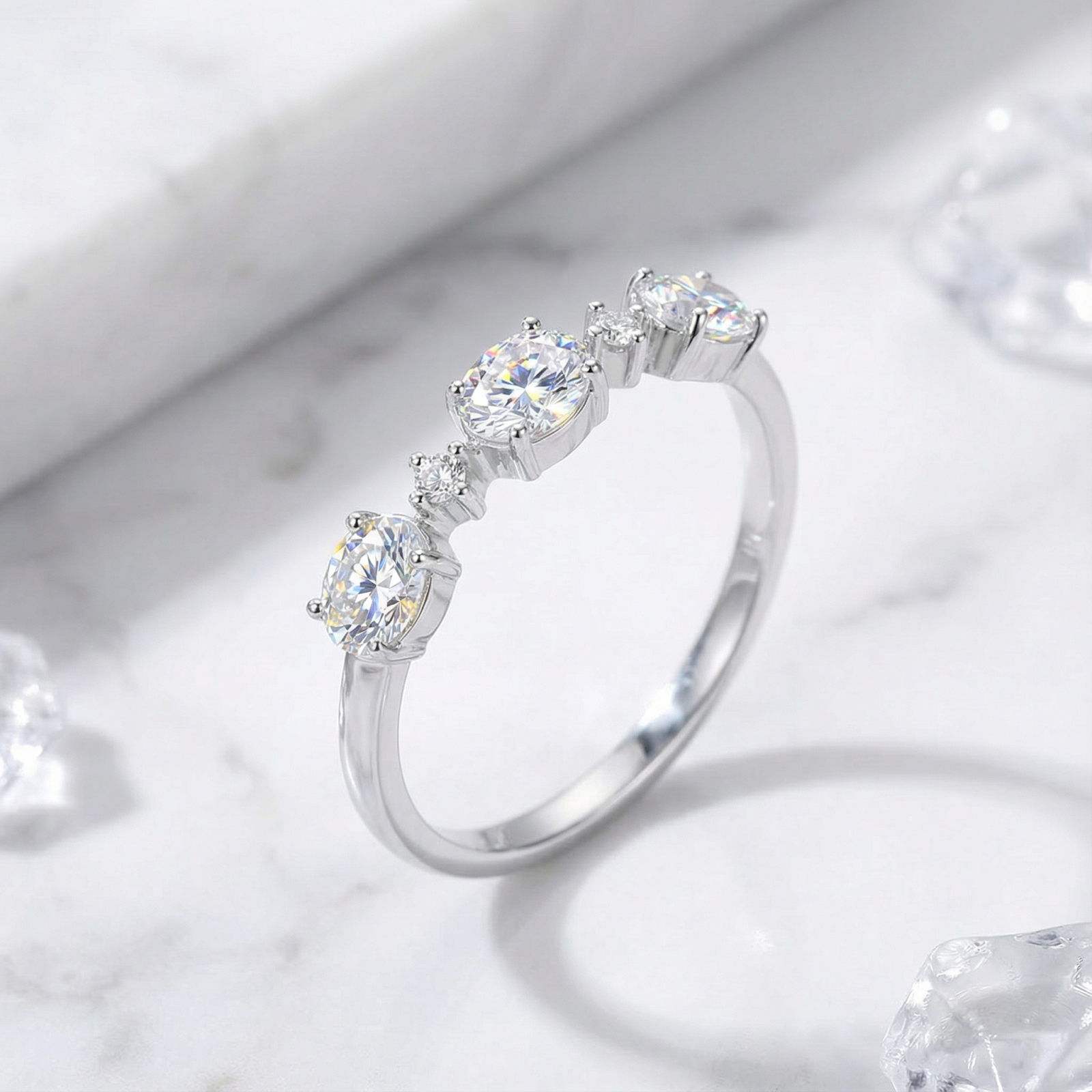 Side view of the Elianne sterling silver ring showing round cut zirconia stones in a low-profile prong setting.