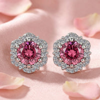 Round cut simulated pink tourmaline halo stud earrings in S925 sterling silver on pink fabric with rose petals.