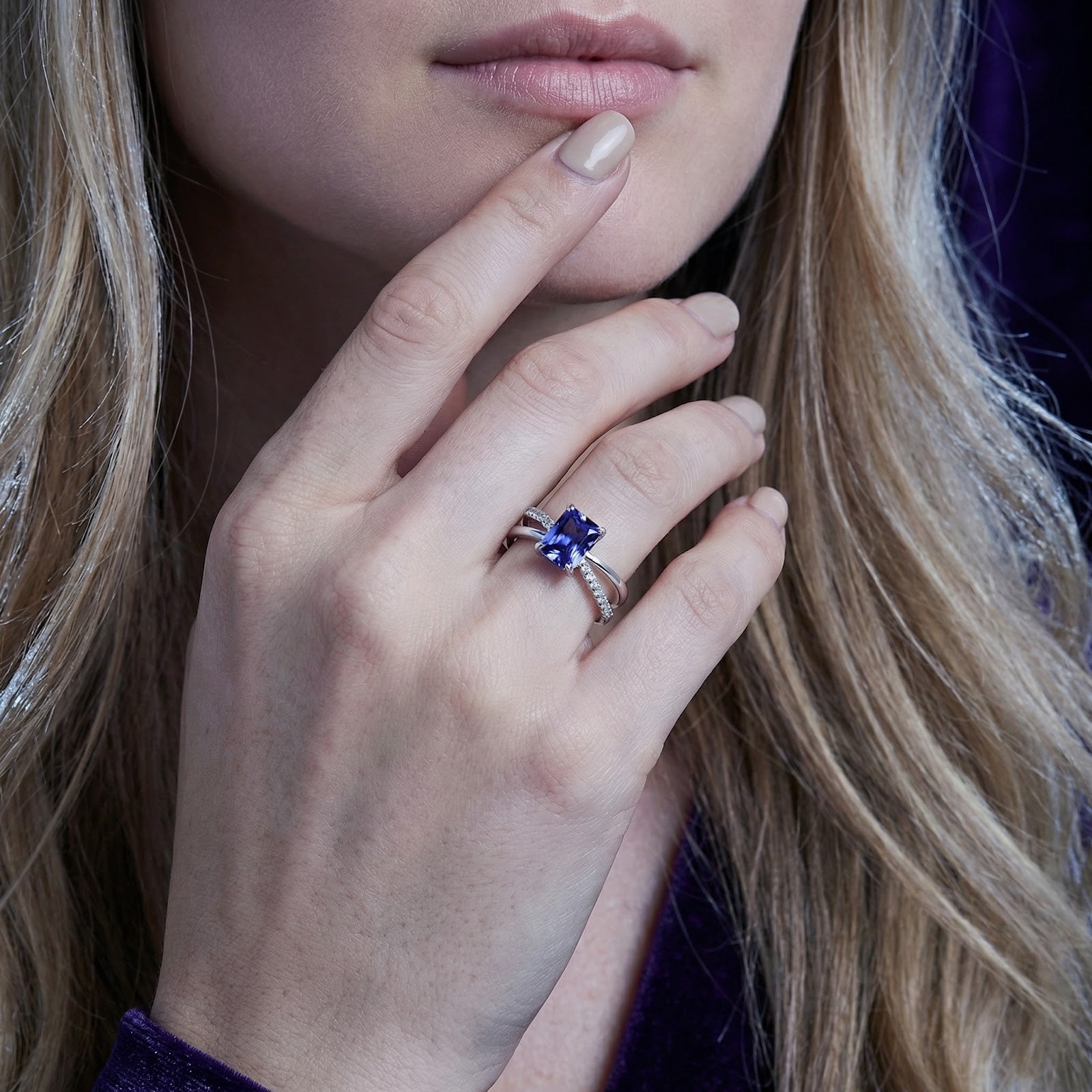 Close-up of a woman wearing the Aurelline sterling silver radiant-cut simulated tanzanite ring.