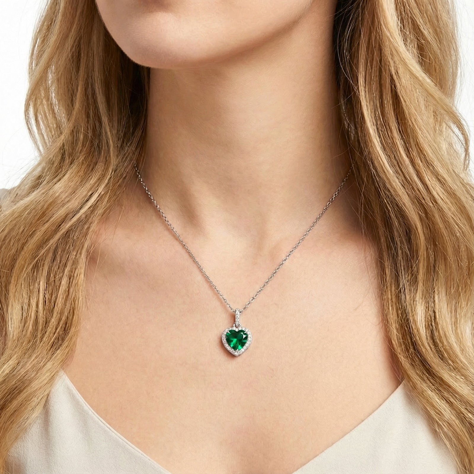 Frontal view of a model wearing the heart-cut simulated emerald necklace in S925 sterling silver.
