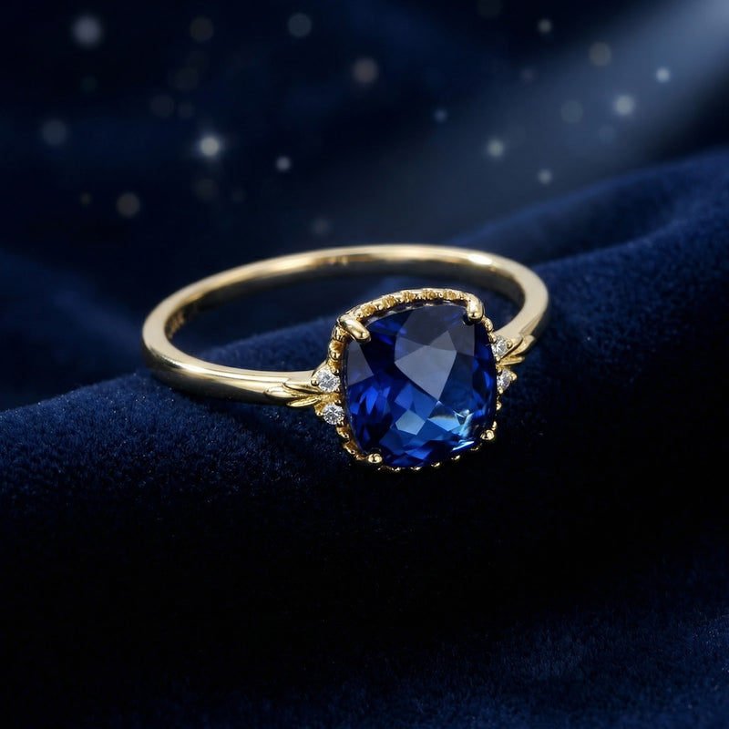 Angled view of the Arisara 18K gold vermeil ring with a cushion-cut royal blue simulated sapphire.