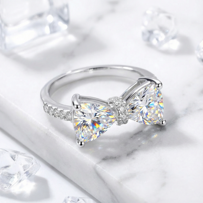 Close-up of the trillion-cut simulated diamond bow setting on a rhodium-plated sterling silver ring.