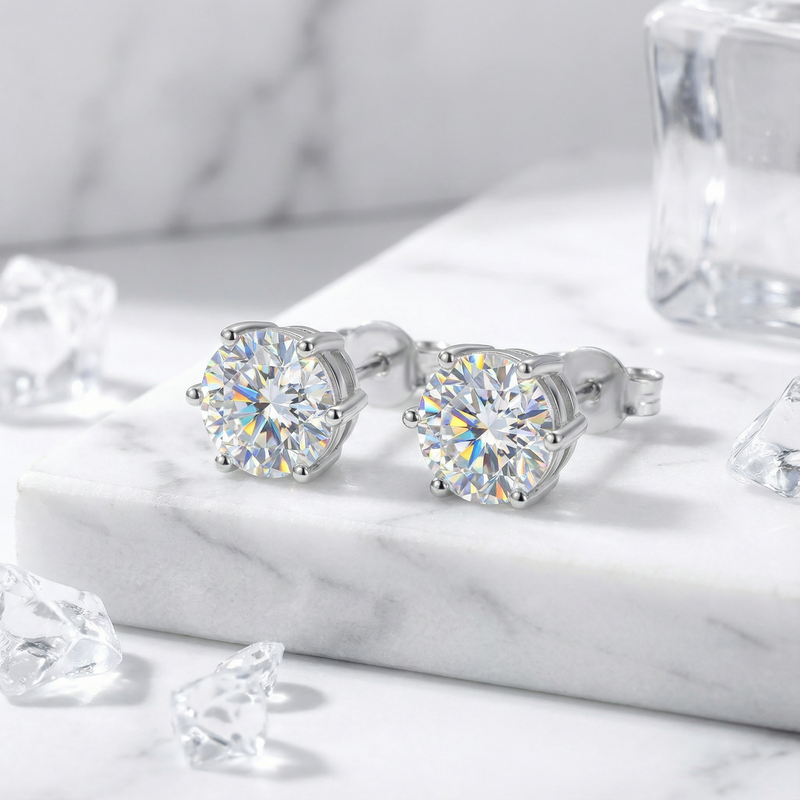 Macro view of round cut simulated diamond stud earrings in a 6-prong sterling silver setting.