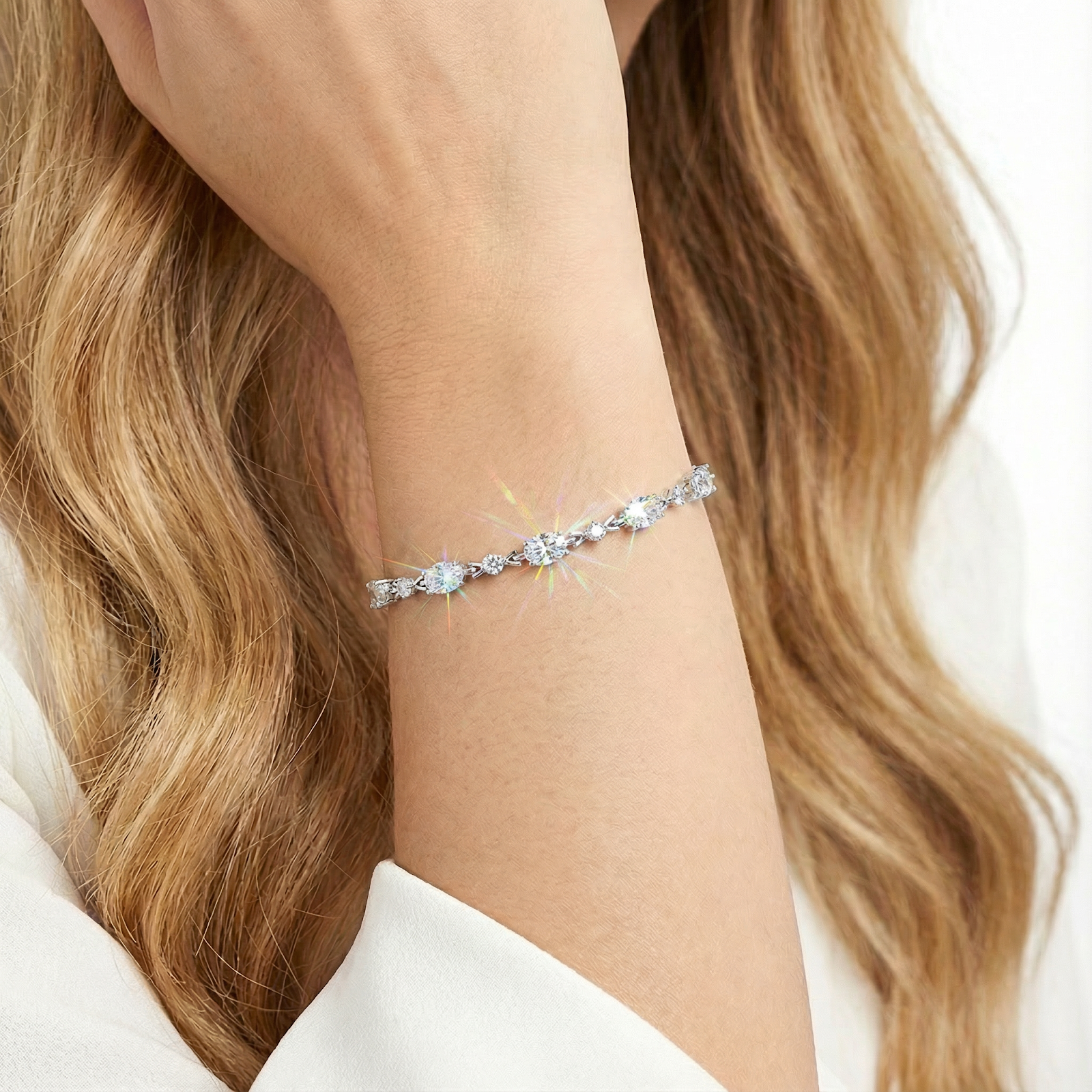 Sparkling oval cut simulated diamond birthstone bracelet worn on a woman's wrist.