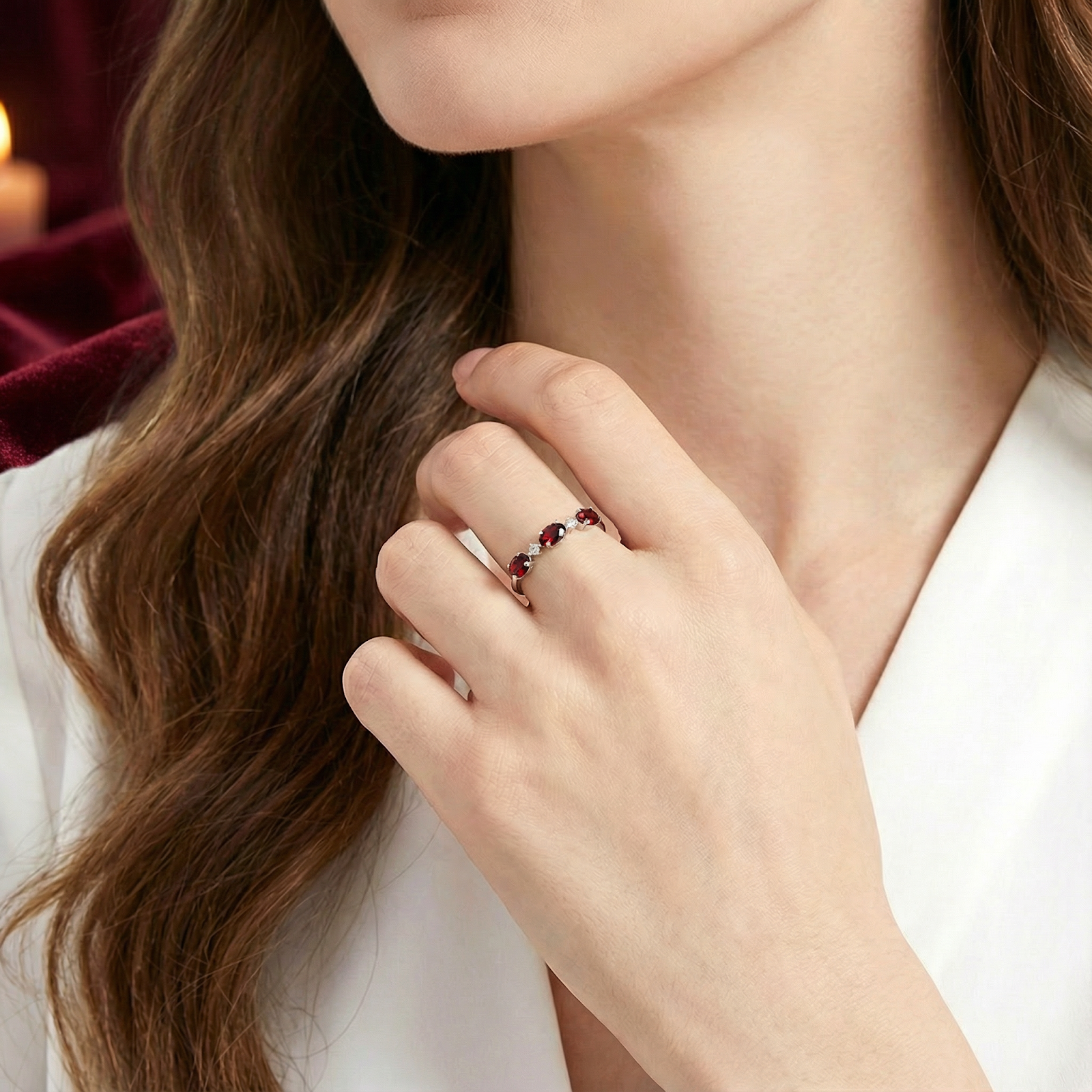 Model wearing the S925 sterling silver bypass ring with round red garnets on her finger.