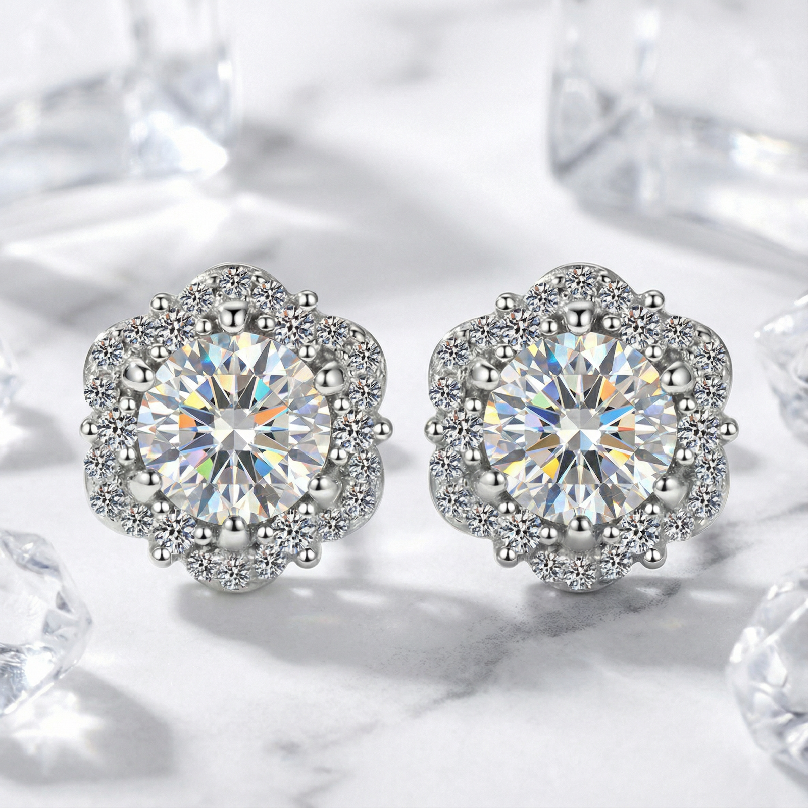 Front view of Isolde halo stud earrings in S925 sterling silver with round cut A5 zirconia on marble.
