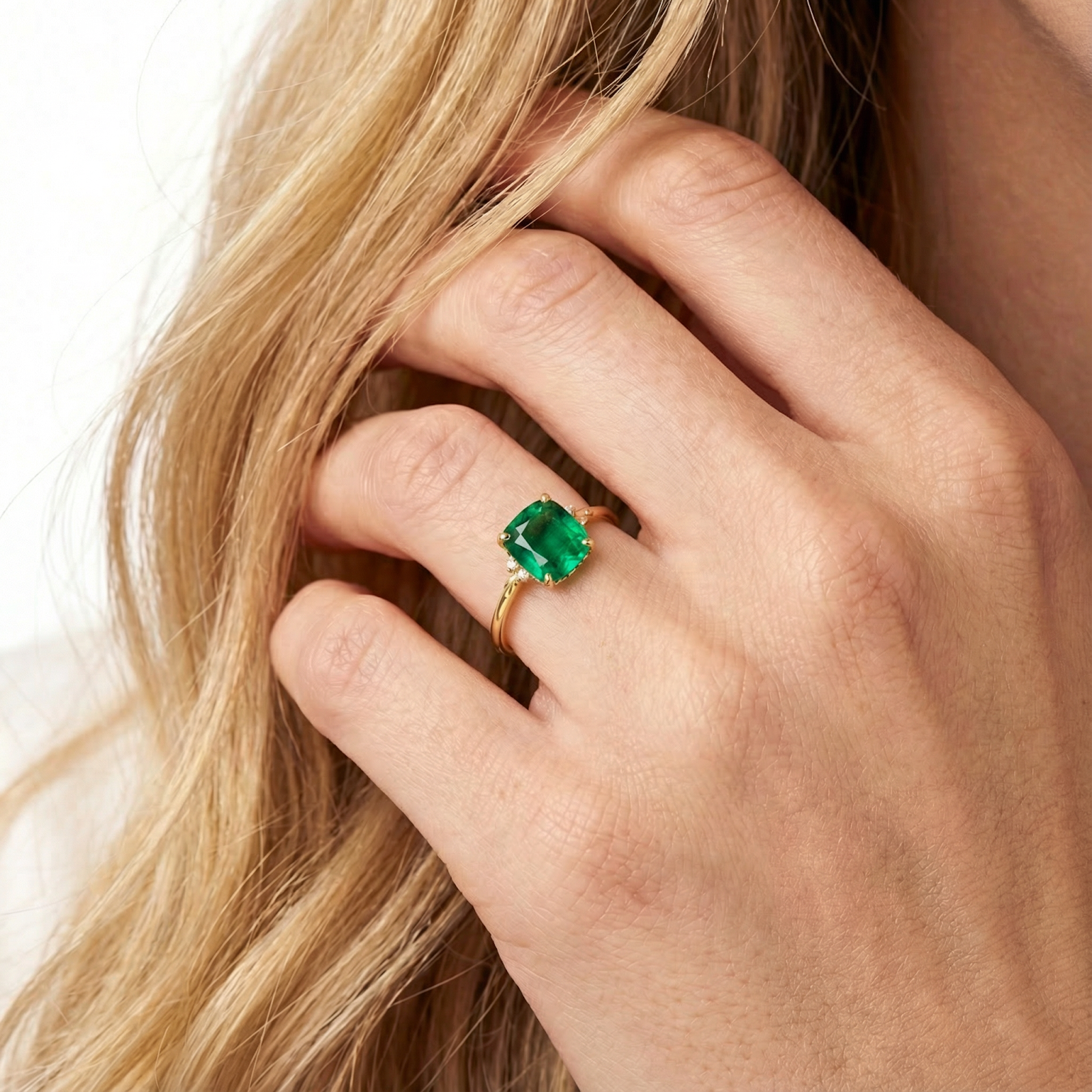 Cushion-cut simulated emerald solitaire ring in 18K gold vermeil shown on a model's hand.