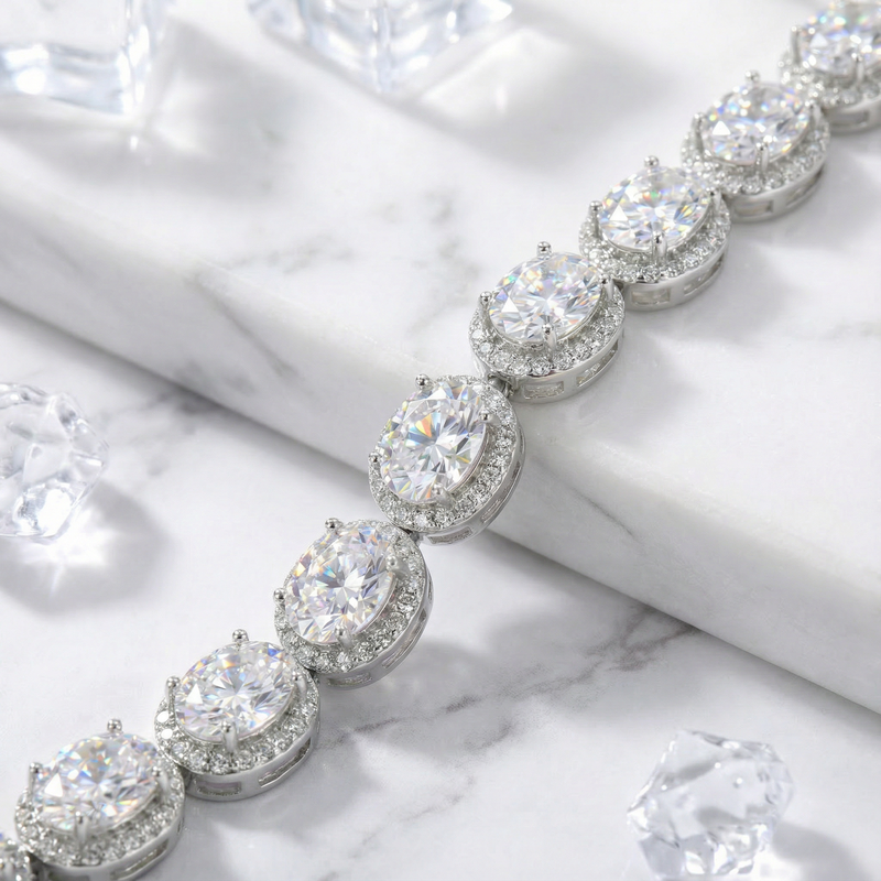 Close-up of oval-cut 5A zirconia stones in protective halo settings on a sterling silver bracelet.