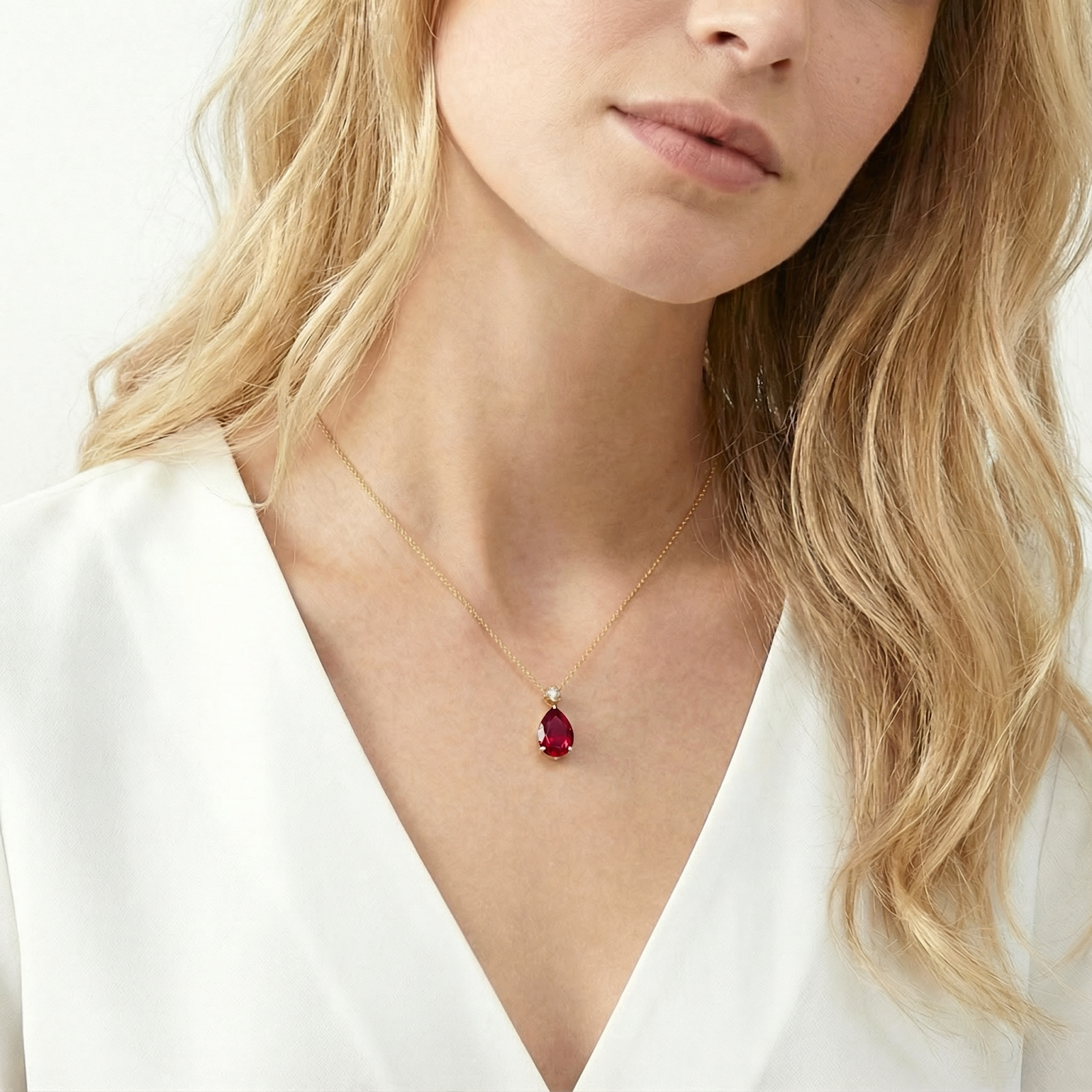 18K gold vermeil necklace with a teardrop simulated ruby pendant worn by a model.