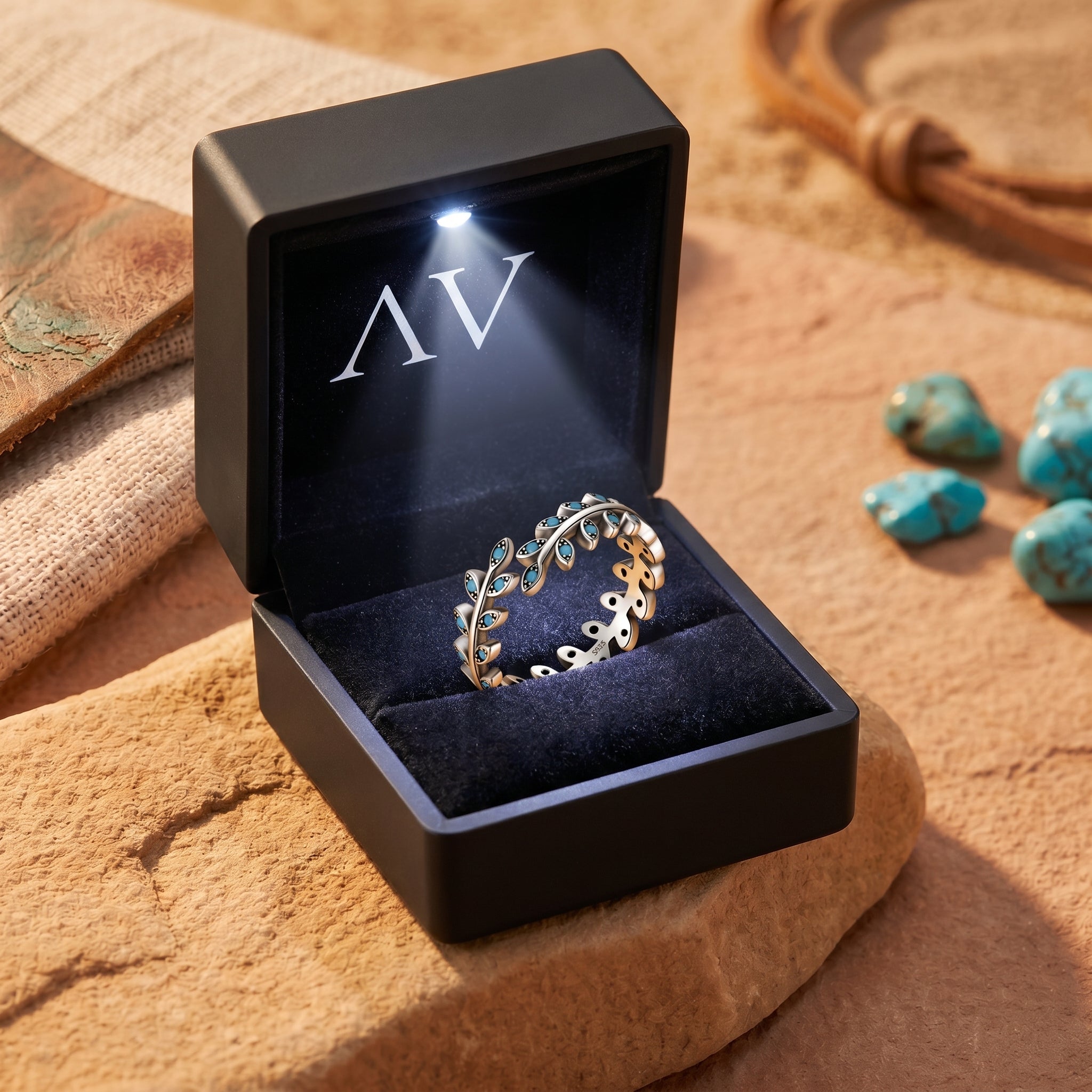 Sterling silver turquoise leaf ring displayed inside a black LED-lighted jewelry box for presentation.