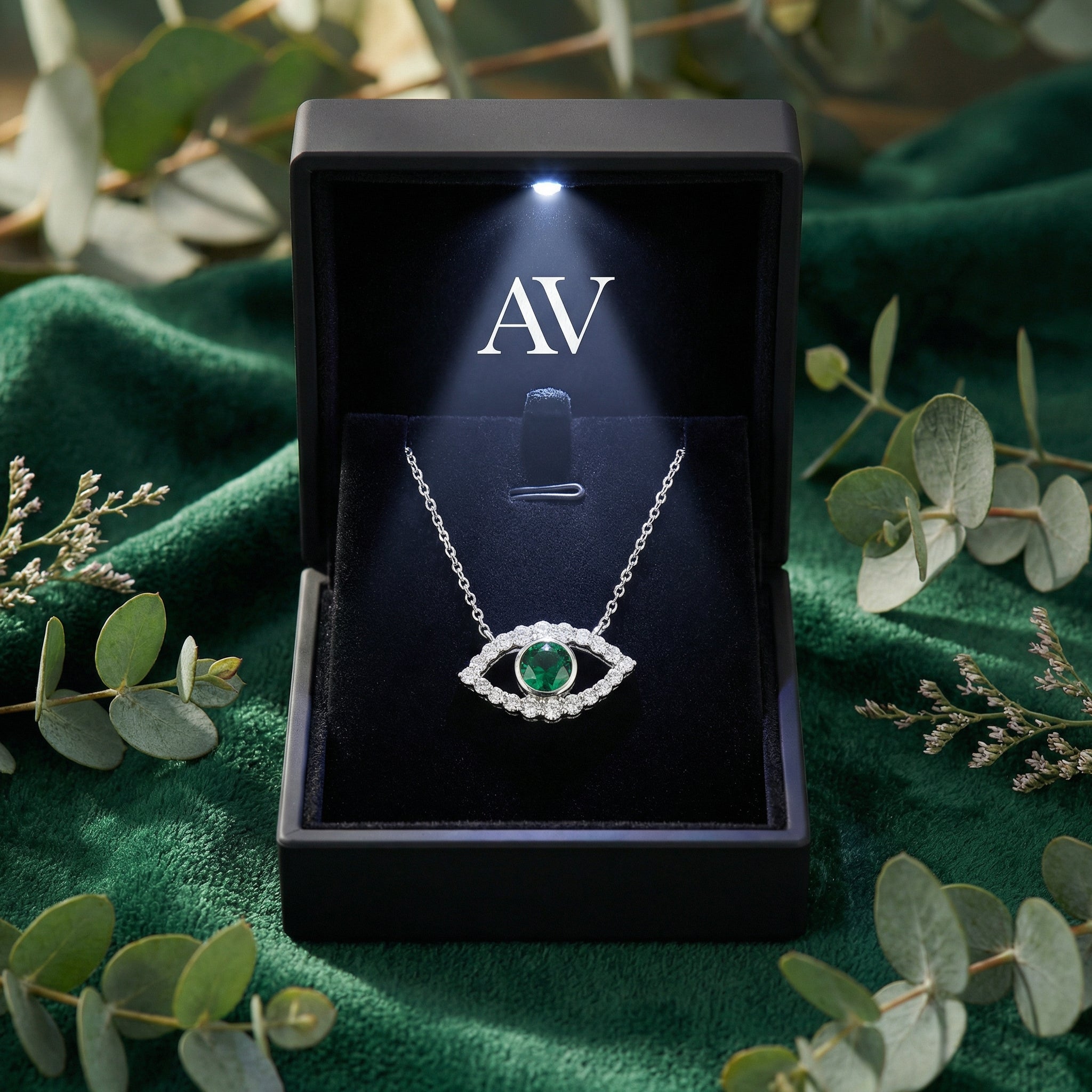 S925 sterling silver simulated emerald evil eye necklace inside a black LED-lit jewelry presentation box.