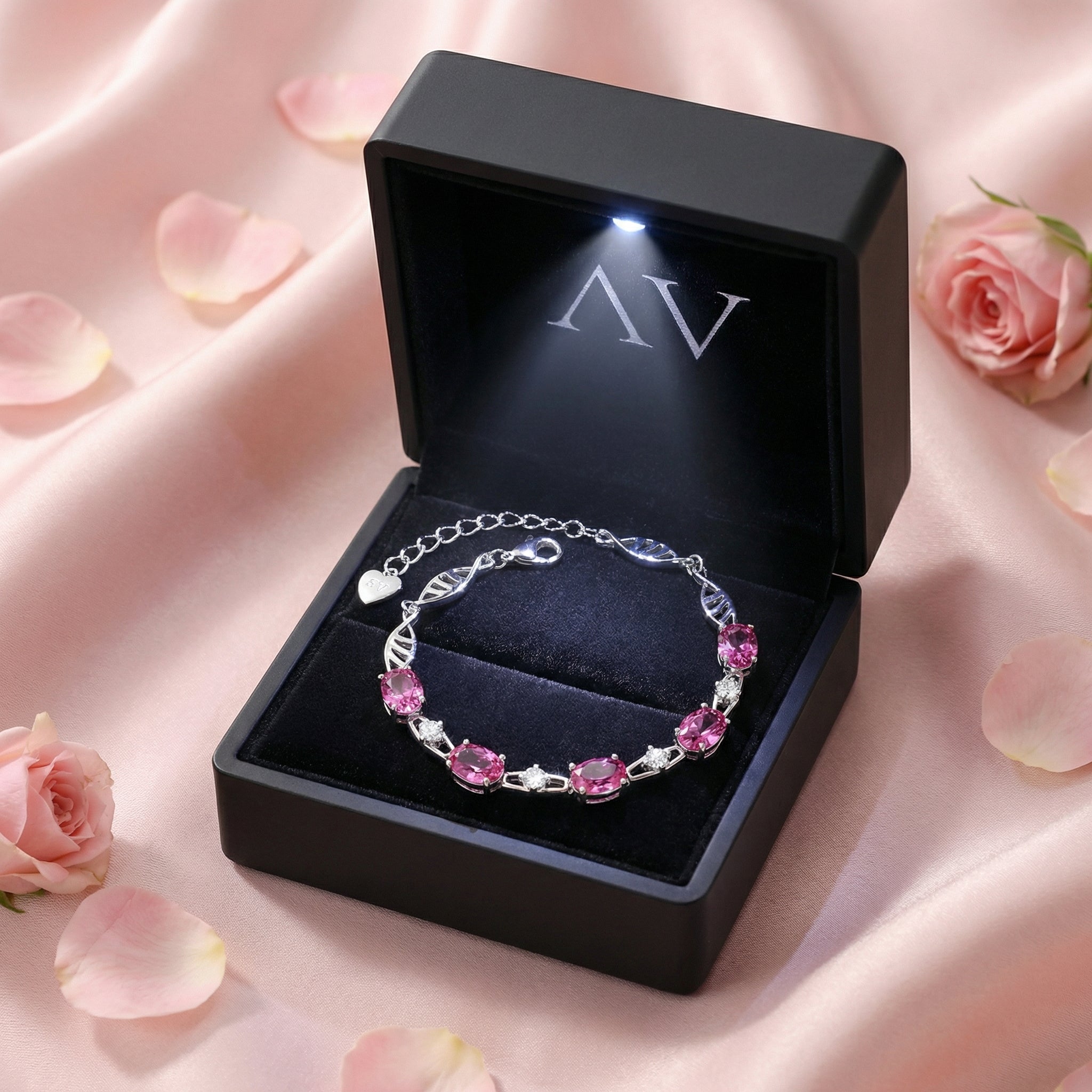 Nerisara pink tourmaline bracelet in a premium black lighted gift box on a pink satin background.