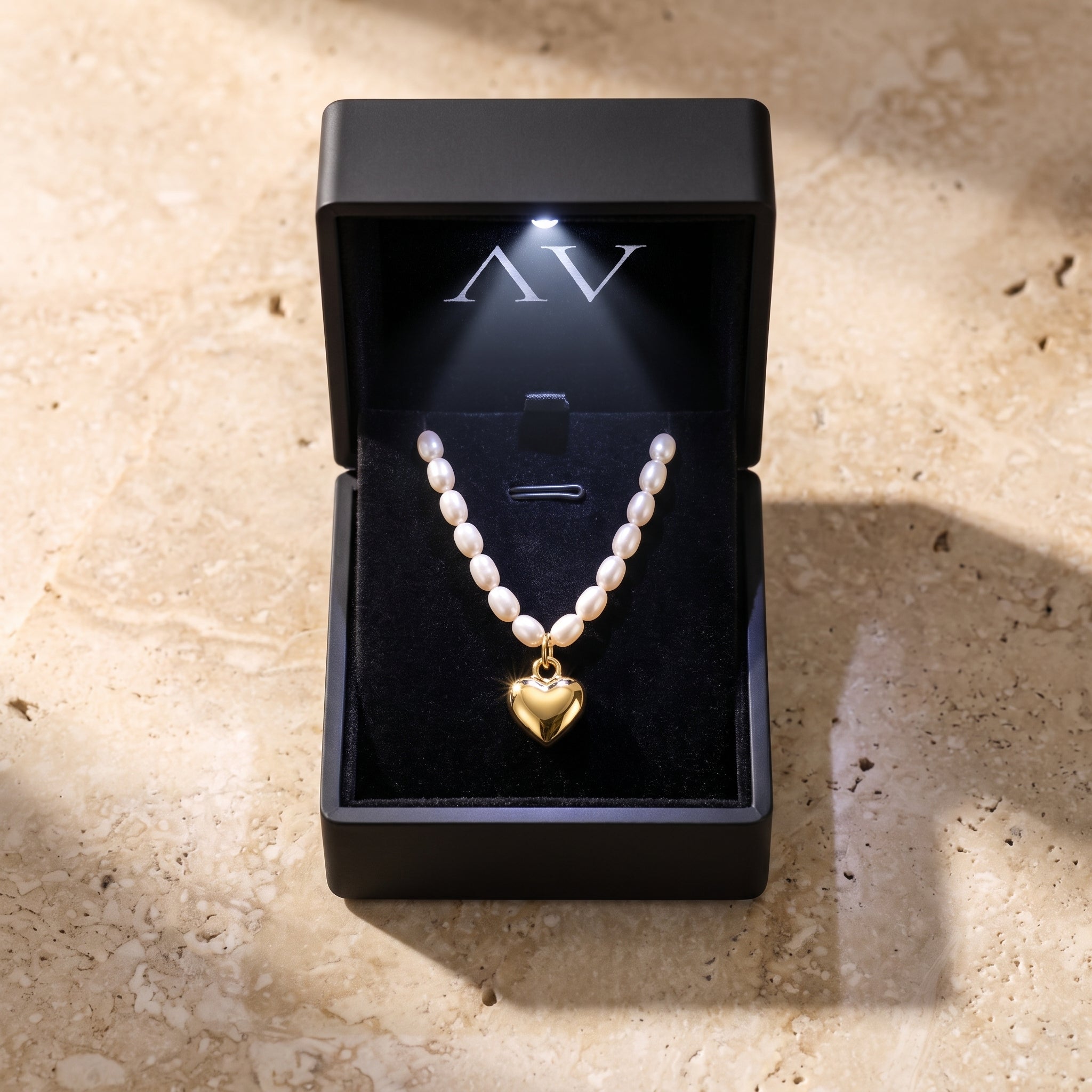 Solid yellow gold heart and white synthetic pearl necklace.