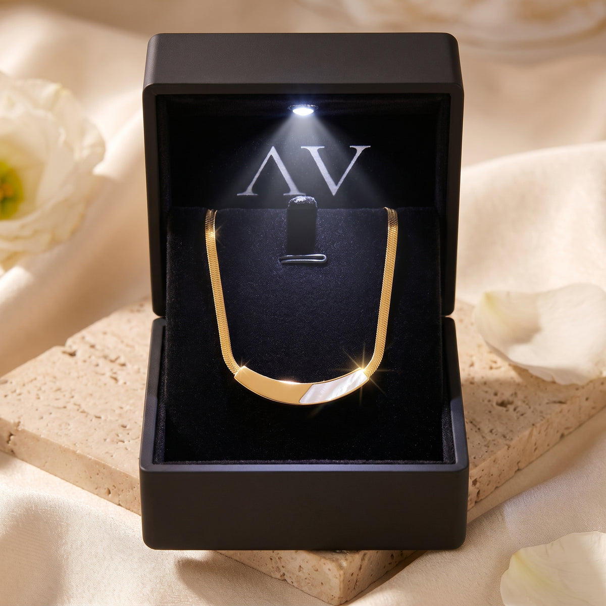 Gold mother of pearl necklace displayed inside a premium black LED-lit jewelry gift box.