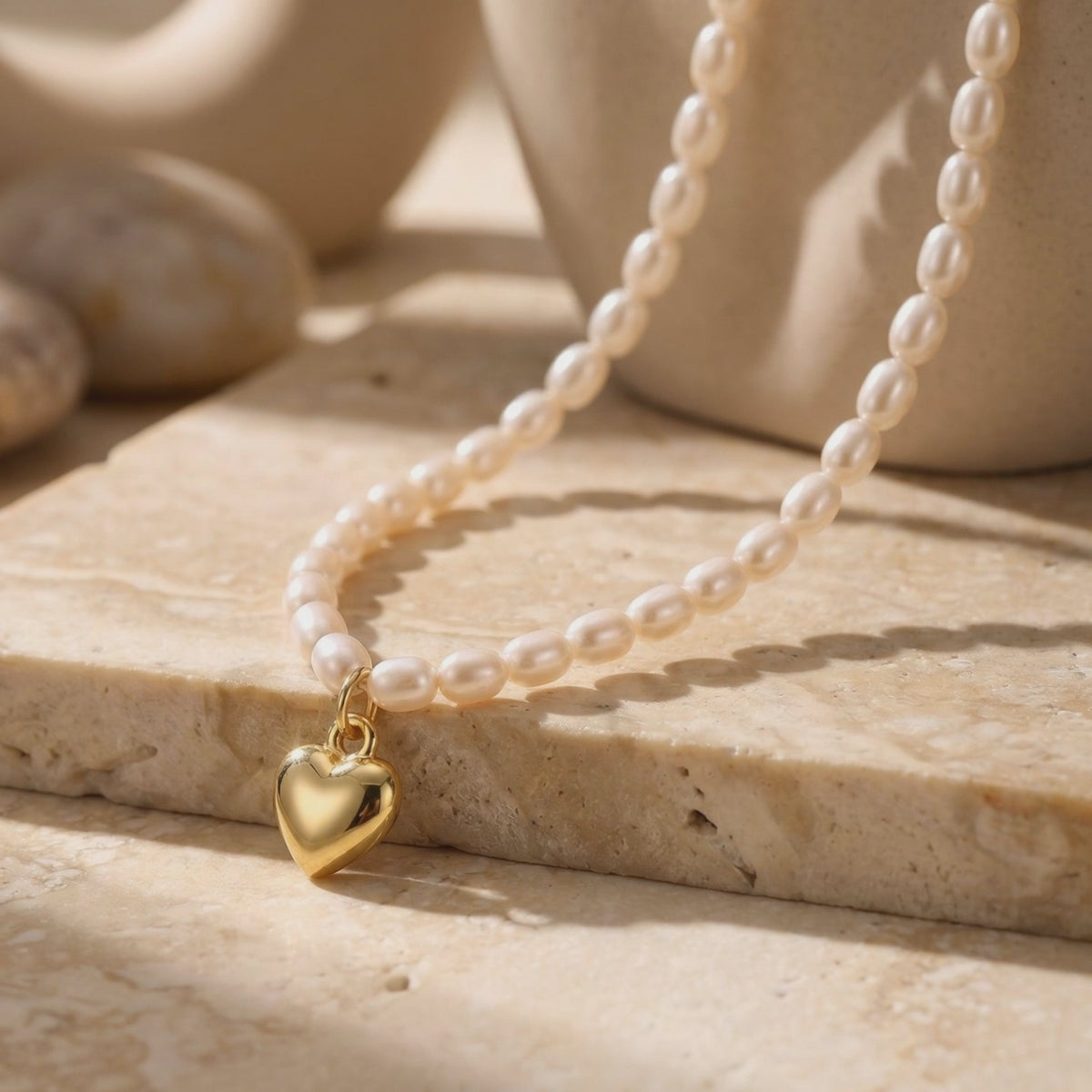 Video of The Colette Pearl Heart Pendant Necklace in solid yellow gold with synthetic pearls.