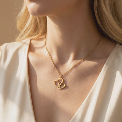 Gold-tone Milana necklace with an interlocking double-heart pendant worn on a model's neck.
