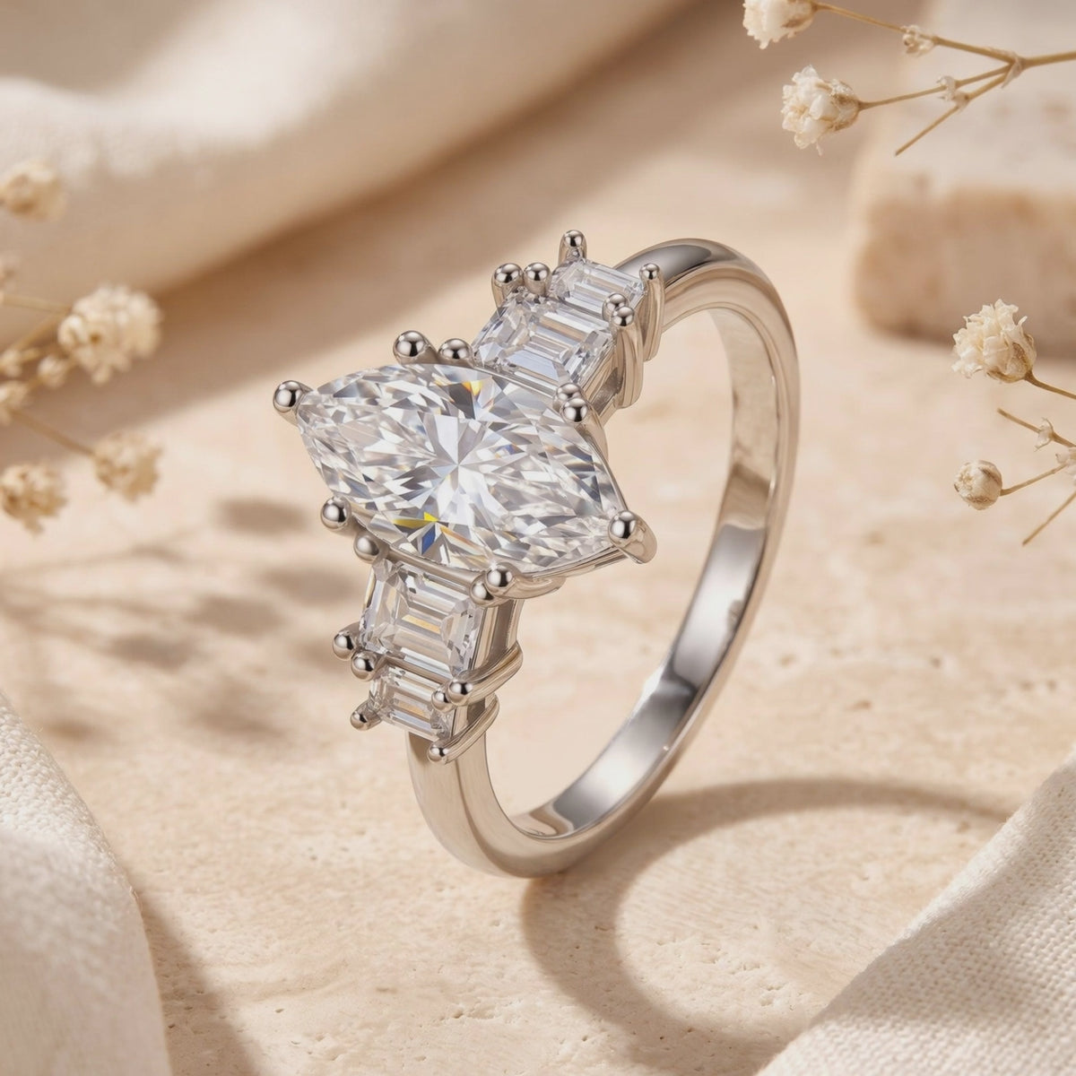 Close-up view of the silver Melanthe Ring with a marquise clear center stone and baguette side accents.