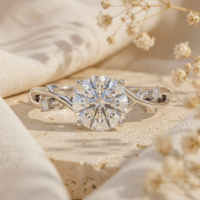 Close-up of the silver-toned round moissanite ring with a branch-inspired vine band.