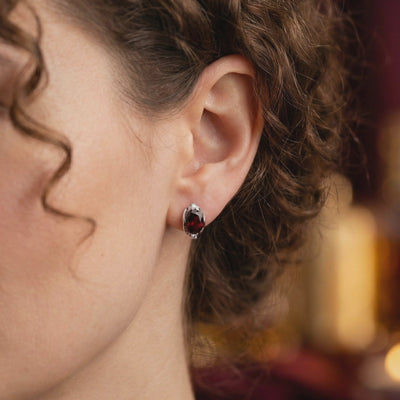 A video showcasing the Alessia 8x10mm oval cut natural garnet drop earrings in solid gold.