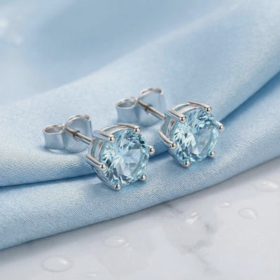 Simulated aquamarine stud earrings in solid gold.