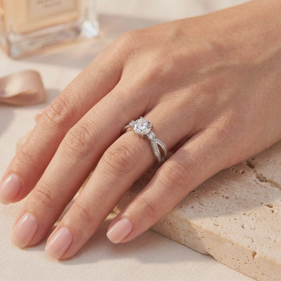 Hand wearing a silver promise ring with a round clear center stone and micro-pavé split bypass band.