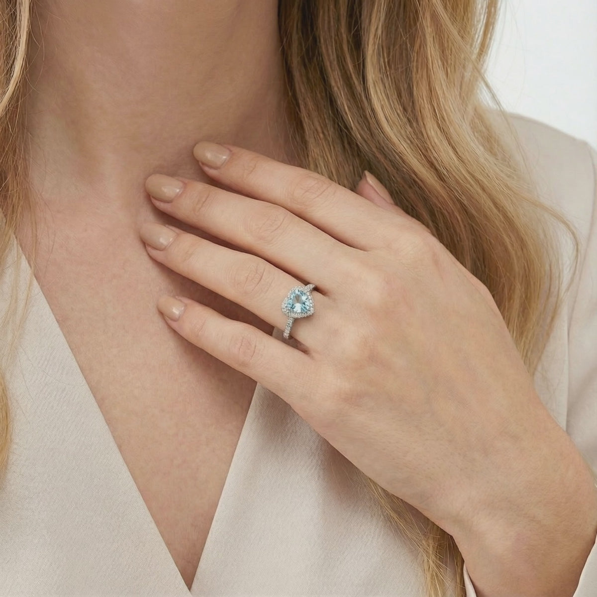 Simulated aquamarine heart halo ring in solid gold.