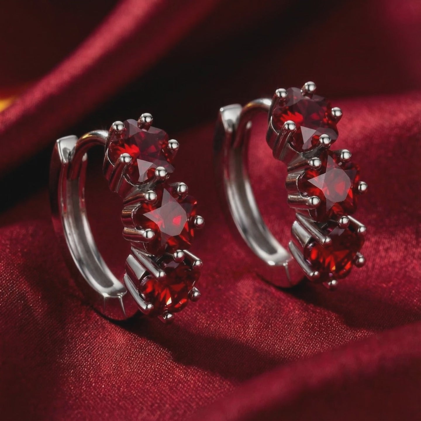 Star-cut simulated ruby huggie earrings in solid gold.