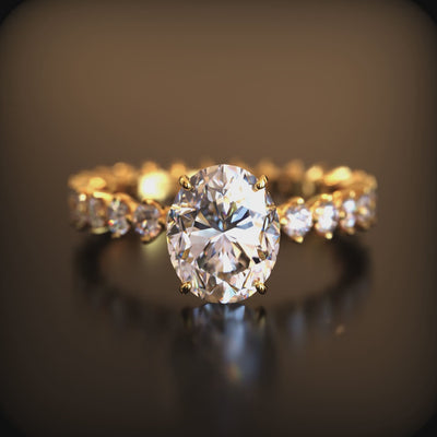 A solid gold ring with an oval moissanite center stone and eternity band.