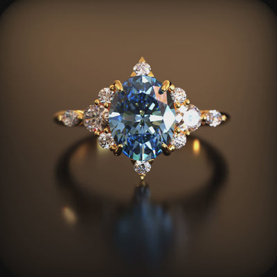 Video of The Carlotta 2 carat oval blue moissanite ring in solid gold, with clear side stones.