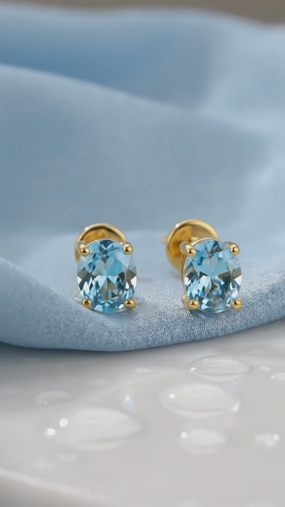 Oval Simulated Aquamarine Solid Gold Stud Earrings.