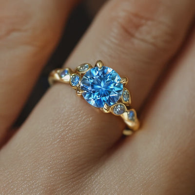 Video of The Katalina solid gold ring with a blue moissanite center stone.